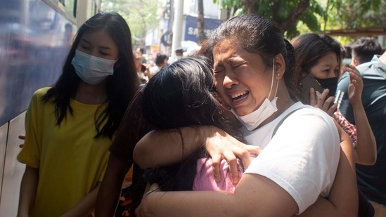 Protesters detained by police during the anti-coup demonstrations react after being released at Tamwe township police station in Yangon, Myanmar. (Reuters)