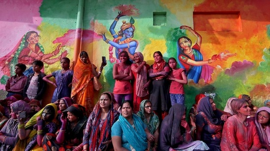 People watch Lathmar Holi celebrations, amidst the spread of the coronavirus disease (Covid-19), in the town of Nandgaon, in the northern state of Uttar Pradesh, India, March 24, 2021. (Reuters)
