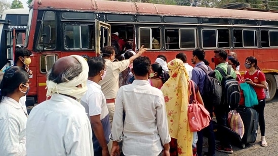 Violation of social distancing norms is being committed before taking a State Transport Bus amid the city reported a surge in COVID-19 cases, in Nagpur on Wednesday. (ANI Photo)