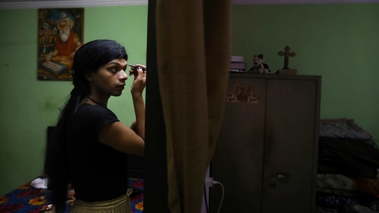 Tashi Singh, 21, a transwoman and an aspiring model, applies makeup at her apartment in New Delhi on March 18. Singh chose the lockdown to implement the toughest decision she had made in her life. For years, the 21-year-old told AP, she had known she was “a woman trapped in a man’s body." When she told her parents, they were unsupportive and hostile. (Manish Swarup)