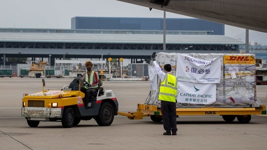 Refrigerated shipping containers carrying the BioNTech Covid-19 vaccine imported by Fosun Pharma are transported at the Hong Kong International Airport in Hong Kong, China, on Saturday, Feb. 27, 2021. (Bloomberg)