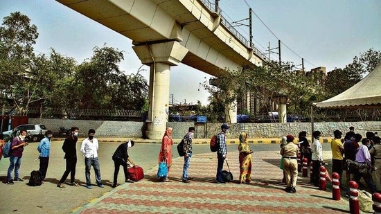 Passengers wait in queue for a Covid-19 test at Anand Vihar bus terminal on Wednesday. (Photo: AP) Passengers wait in queue for a Covid-19 test at Anand Vihar bus terminal on Wednesday. (Photo: AP)