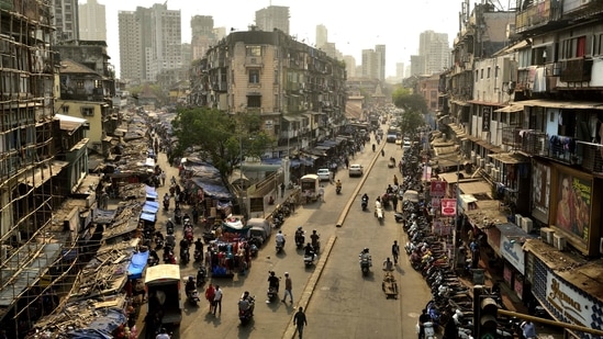 Null Bazar, nearly a year later on March 20, with the marked presence of roadside stalls signaling a return to business, albeit at levels lower than before. A stream of commuters however, appears to take up more space than people out shopping.(Anshuman Poyrekar / HT Photo)