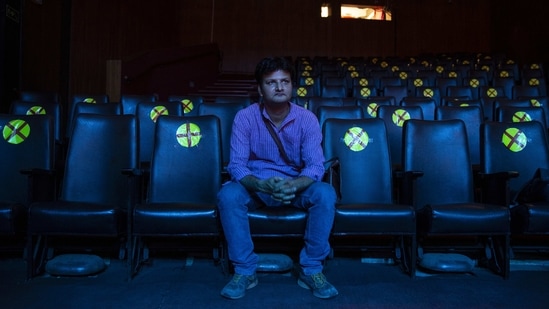 Neelesh Deepak watches a rehearsal of an upcoming show he is managing at a theatre in New Delhi on March 16. When Deepak returned back to the capital in October, things had changed. Most theatres had closed. Upcoming shows were suspended indefinitely and thousands of his peers had no jobs. His struggle continued for months until he eventually joined a nonprofit group as a researcher. His income plummeted from between $500 to $600 a month to a little more than $150. He struggles just to buy food.(Altaf Qadri/AP)