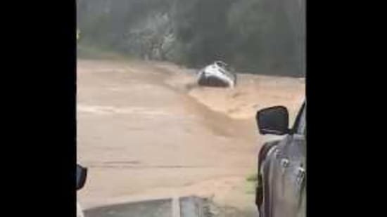 The image shows the car being swept away.(Twitter/@TMRQld)
