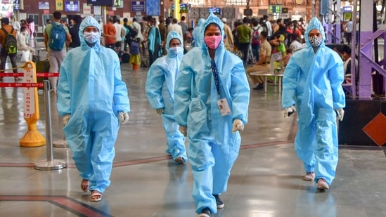 Health workers wearing PPE kits walk on a platform at CSMT, in Mumbai, Wednesday, March 24, 2021. (PTI) Health workers wearing PPE kits walk on a platform at CSMT, in Mumbai, Wednesday, March 24, 2021. (PTI)