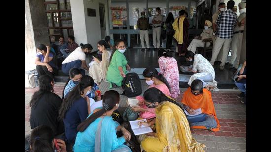 Students assembled outside the AC Joshi library at Panjab University in Chandigarh on Wednesday. (Ravi Kumar/HT)