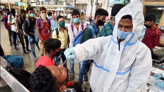 A healthcare worker takes a swab sample of a passenger for Covid-19 test at Chhatrapati Shivaji Maharaj Terminus, in Mumbai earlier this month. (File photo)