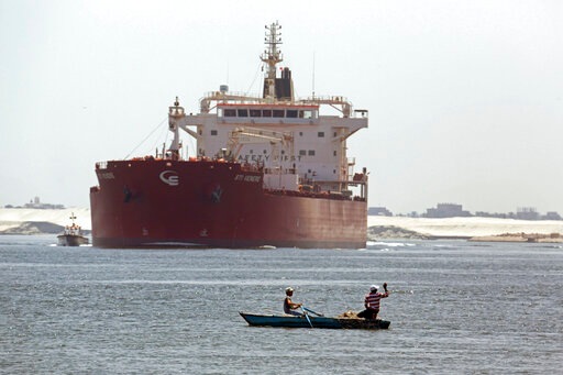 FILE - In this Aug. 12, 2014, file photo, Egyptian fishermen fish in front of a Maltese ship crossing the Suez Canal in Ismailia, Egypt. A massive cargo ship has turned sideways in Egypt's Suez Canal, blocking traffic in a crucial East-West waterway for global shipping, according to satellite data accessed Wednesday, March 24, 2021. (AP Photo/Amr Nabil, File) (AP) FILE - In this Aug. 12, 2014, file photo, Egyptian fishermen fish in front of a Maltese ship crossing the Suez Canal in Ismailia, Egypt. A massive cargo ship has turned sideways in Egypt's Suez Canal, blocking traffic in a crucial East-West waterway for global shipping, according to satellite data accessed Wednesday, March 24, 2021. (AP Photo/Amr Nabil, File) (AP)