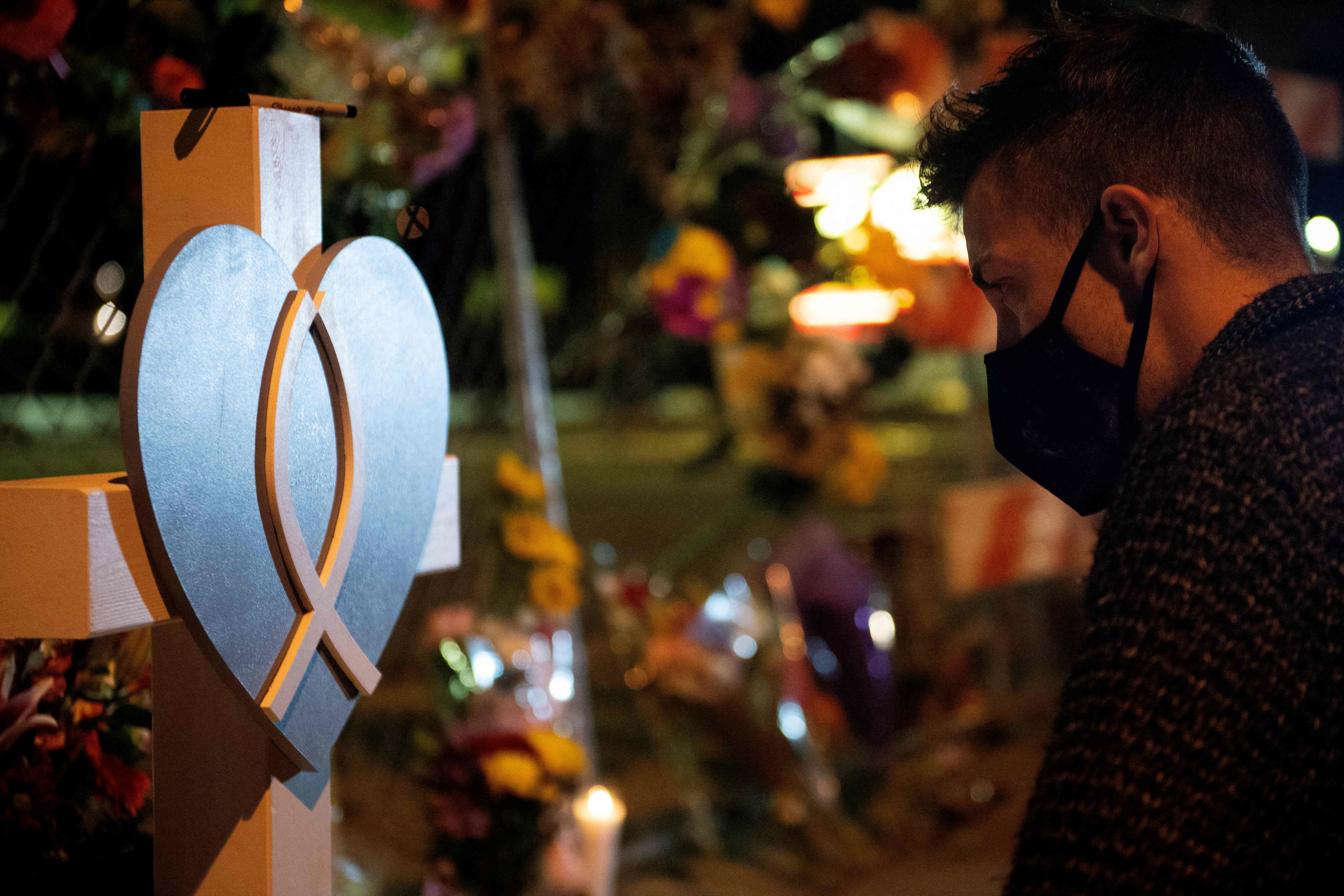 People reflect as they pay their respects to the ten victims of a mass shooting at a King Soopers grocery store in Boulder, Colorado. (AFP) People reflect as they pay their respects to the ten victims of a mass shooting at a King Soopers grocery store in Boulder, Colorado. (AFP)