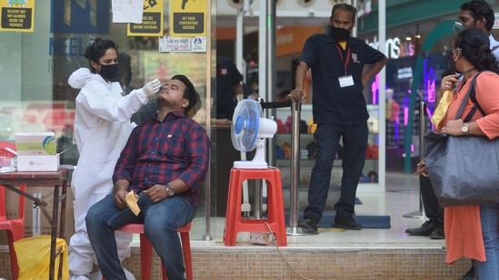 A BMC health care workers taking a swab of people outside a shopping mall at Dadar in Mumbai, India, on Thursday, March 25, 2021. (Photo by Satish Bate/Hindustan Times)(Satish Bate/HT Photo)