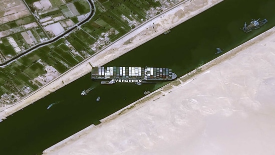 This handout satellite images courtesy of Cnes 2020 released on March 25, 2021 by Airbus DS shows the Taiwan-owned MV 'Ever Given' (Evergreen) container ship, a 400-metre- (1,300-foot-)long and 59-metre wide vessel, lodged sideways and impeding all traffic across the waterway of Egypt's Suez Canal. (AFP) This handout satellite images courtesy of Cnes 2020 released on March 25, 2021 by Airbus DS shows the Taiwan-owned MV 'Ever Given' (Evergreen) container ship, a 400-metre- (1,300-foot-)long and 59-metre wide vessel, lodged sideways and impeding all traffic across the waterway of Egypt's Suez Canal. (AFP)