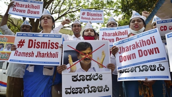 Members of the Aam Adami Party raise slogans against Karnataka Minister Ramesh Jarkiholi for his alleged involvement in CD row in Bengaluru, Wednesday, March 3, 2021. (PTI) Members of the Aam Adami Party raise slogans against Karnataka Minister Ramesh Jarkiholi for his alleged involvement in CD row in Bengaluru, Wednesday, March 3, 2021. (PTI)