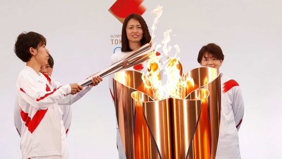 The torch is lit by a member of Japan's women's national soccer team "Nadeshiko Japan" during the Tokyo 2020 Olympic Torch Relay Grand Start in Naraha, Fukushima prefecture, northeastern Japan, Thursday, March 25, 2021. The torch relay for the postponed Tokyo Olympics began its 121-day journey across Japan on Thursday and is headed toward the opening ceremony in Tokyo on July 23. (AP)