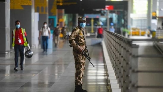 A CISF personnel wears a face mask as he stand guards, at IGI Airport, amid the lockdown, in New Delhi.(Amal KS/HT Photo)