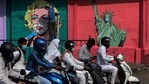 An artist paints a mural of Marilyn Monroe, beside one of the Statue of Liberty wearing face masks to spread awareness for the prevention of the coronavirus in Mumbai, India, Friday, March. 26, 2021. (AP) An artist paints a mural of Marilyn Monroe, beside one of the Statue of Liberty wearing face masks to spread awareness for the prevention of the coronavirus in Mumbai, India, Friday, March. 26, 2021. (AP)