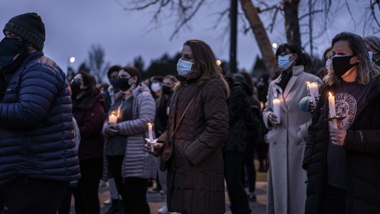 Mourners attend a vigil to commemorate the victims of a mass shooting at a King Soopers grocery store on Thursday, March 25, 2021, in Boulder, Colorado. (AFP) Mourners attend a vigil to commemorate the victims of a mass shooting at a King Soopers grocery store on Thursday, March 25, 2021, in Boulder, Colorado. (AFP)