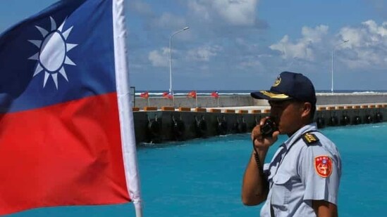 A member of the Taiwanese Coast Guard stands guard next to a Taiwanese flag on Itu Aba, which the Taiwanese call Taiping, at the South China Sea, November 29, 2016. REUTERS/J.R Wu/File Photo(REUTERS)