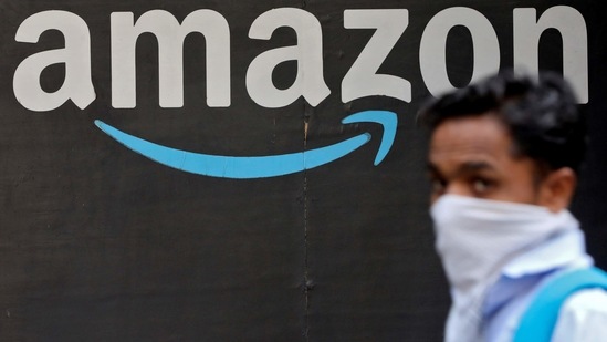 A man walks past an Amazon logo outside the company's collection point in Mumbai, India.(REUTERS)