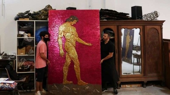 Argentine artist Marcelo Toledo (R) and his assistant Facundo Mineldin shift an art piece depicting Adam, which will be part of the "Museum of the After", at his workshop in Buenos Aires, Argentina March 4, 2021. (REUTERS)