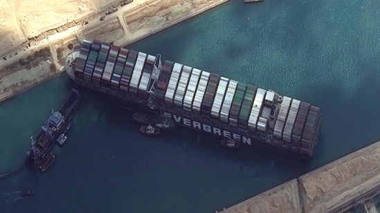 This satellite imagery released by Maxar Technologies shows tug boats and dredgers attempting to free the MV Ever Given on March 26, 2021, in the Suez Canal. (AFP) This satellite imagery released by Maxar Technologies shows tug boats and dredgers attempting to free the MV Ever Given on March 26, 2021, in the Suez Canal. (AFP)