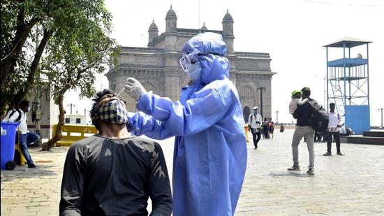 A BMC health worker collects a swab sample to test for Covid-19 infection, at Gateway of India. (Anshuman Poyrekar/HT Photo) A BMC health worker collects a swab sample to test for Covid-19 infection, at Gateway of India. (Anshuman Poyrekar/HT Photo)