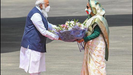 Prime Minister Narendra Modi being received by Bangladesh PM Sheikh Hasina, in Dhaka on Friday, March 26. (PTI) Prime Minister Narendra Modi being received by Bangladesh PM Sheikh Hasina, in Dhaka on Friday, March 26. (PTI)