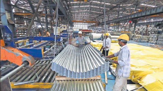 Employees guide finished corrugated steel roofing onto a pallet in the tube mill at the manufacturing facility of Uttam Galva Steels Ltd., the Indian unit of ArcelorMittal, in Khopoli, Maharashtra, India, on Friday, June 13, 2014. ArcelorMittal, the world’s largest steelmaker and one of the few foreign steel mills with investments in China, welcomed the potential removal of a near 10-year block on overseas takeovers in China’s steel industry. Photographer: Vivek Prakash/Bloomberg (Bloomberg)