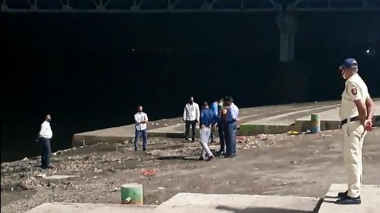 NIA brought police officer Sachin Vaze, accused of Mansukh Hiran’s murder, to the Thane Mumbra creek for investigation, on Thursday. (PTI) NIA brought police officer Sachin Vaze, accused of Mansukh Hiran’s murder, to the Thane Mumbra creek for investigation, on Thursday. (PTI)