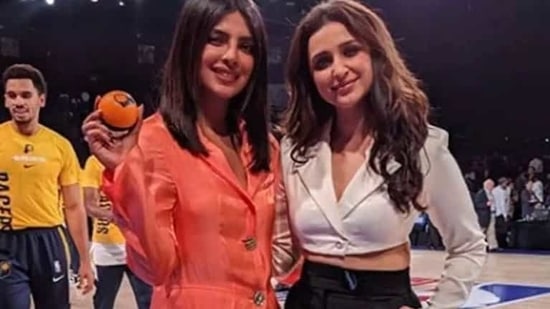 Parineeti Chopra and Priyanka Chopra pose together.