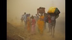Migrant workers walking towards Farrukhabad and Sultanpur pause during a sudden dust storm, Ghaziabad, May 10, 2020. (Ajay Aggarwal /HT PHOTO) Migrant workers walking towards Farrukhabad and Sultanpur pause during a sudden dust storm, Ghaziabad, May 10, 2020. (Ajay Aggarwal /HT PHOTO)