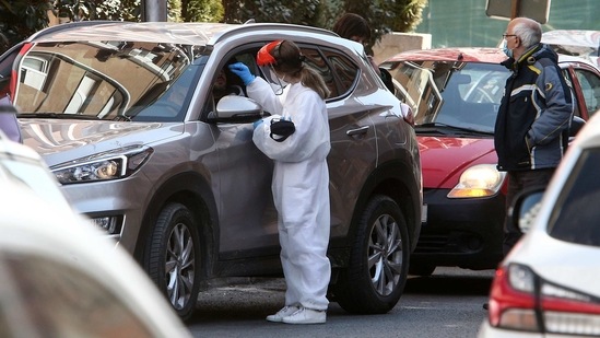 A health worker takes a swab sample for Covid-19 from a man in a vehicle in a street in Skopje, North Macedonia, Friday. A health worker takes a swab sample for Covid-19 from a man in a vehicle in a street in Skopje, North Macedonia, Friday.