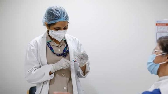 A woman watches as a healthcare worker fills a syringe with a dose of Covishield vaccine manufactured by the Serum Institute of India, at Max Super Speciality Hospital, in New Delhi, India (Reuters). A woman watches as a healthcare worker fills a syringe with a dose of Covishield vaccine manufactured by the Serum Institute of India, at Max Super Speciality Hospital, in New Delhi, India (Reuters).