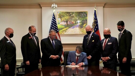 Republican Governor Brian Kemp signs new bill, a restrictive voting law that activists have said aimed to curtail the influence of Black voters.(via REUTERS)
