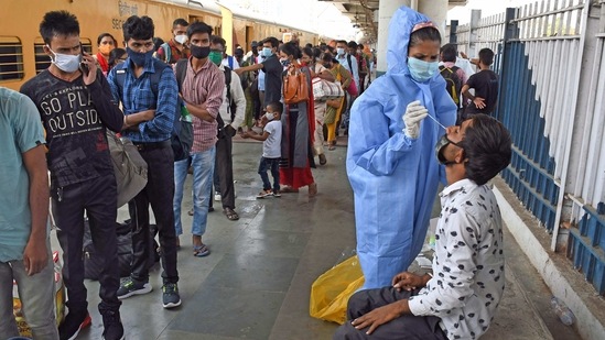 A BMC health worker takes an Antigen test of passengers arriving from Gujarat at Dadar station, in Mumbai on Thursday. (ANI Photo) A BMC health worker takes an Antigen test of passengers arriving from Gujarat at Dadar station, in Mumbai on Thursday. (ANI Photo)