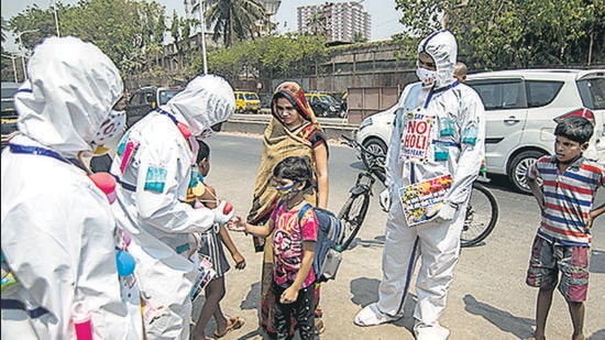 Volunteers distribute pamphlets on Covid-19 awareness to residents of Dharavi on Saturday. (Pratik Chorge/HT Photo) Volunteers distribute pamphlets on Covid-19 awareness to residents of Dharavi on Saturday. (Pratik Chorge/HT Photo)
