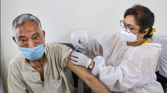 A medic administers Covid-19 vaccine to a senior citizen in Jammu on Saturday. (PTI) A medic administers Covid-19 vaccine to a senior citizen in Jammu on Saturday. (PTI)