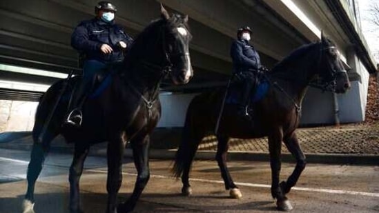 Mounted police patrol in a park in Warsaw, Poland.(AP) Mounted police patrol in a park in Warsaw, Poland.(AP)