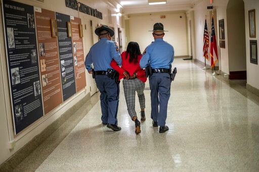Rep. Park Cannon (D-Atlanta) is escorted out of the Georgia Capitol by Georgia state troopers after being asked to stop knocking on a door that lead to Gov. Brian Kemp’s office while Kemp was speaking after signing a sweeping overhaul of state elections behind closed doors in Atlanta. (AP) Rep. Park Cannon (D-Atlanta) is escorted out of the Georgia Capitol by Georgia state troopers after being asked to stop knocking on a door that lead to Gov. Brian Kemp’s office while Kemp was speaking after signing a sweeping overhaul of state elections behind closed doors in Atlanta. (AP)
