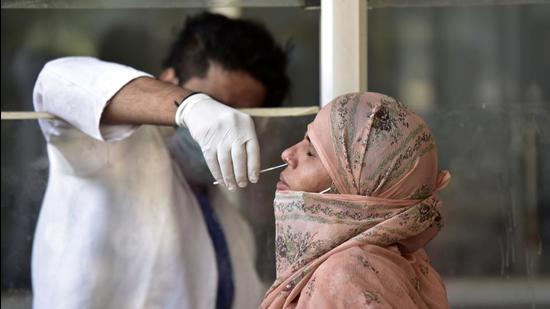 File photo: A health worker collecting a swab sample from a woman for Covid-19 testing. (Sunil Ghosh / Hindustan Times)