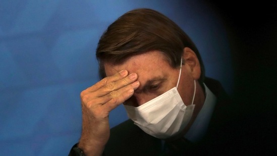 Brazil's President Jair Bolsonaro, wearing protective face mask, listens during a ceremony at the Planalto Presidential Palace, in Brasilia, Brazil. (AP) Brazil's President Jair Bolsonaro, wearing protective face mask, listens during a ceremony at the Planalto Presidential Palace, in Brasilia, Brazil. (AP)