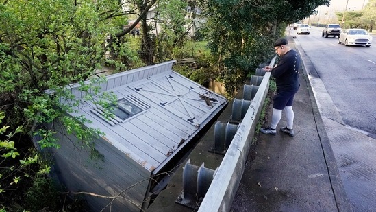 Adam Wirdzek stops to look at a utility building that was carried down a flooded creek in Nashville, Tenn. Heavy rain across Tennessee flooded homes and roads as a line of severe storms crossed the state. (AP) Adam Wirdzek stops to look at a utility building that was carried down a flooded creek in Nashville, Tenn. Heavy rain across Tennessee flooded homes and roads as a line of severe storms crossed the state. (AP)