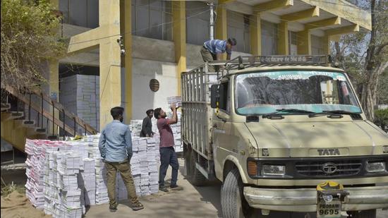 Books being loaded into a truck. New textbooks of Class 12 computer science and Class 7 Mathematics had reached board depots. (HT file)