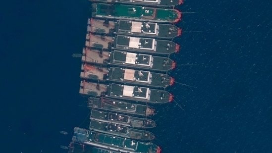 This satellite image provided by Maxar Technologies shows Chinese vessels anchored the Whitsun Reef located in the disputed South China Sea.(via AP)