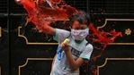 A boy wearing a protective face mask reacts as he is splashed with coloured water during Holi celebrations, in Chennai, on March 29, A boy wearing a protective face mask reacts as he is splashed with coloured water during Holi celebrations, in Chennai, on March 29,