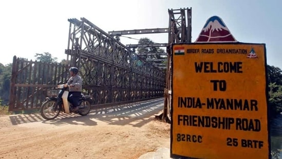 A man rides his motorised two-wheeler across the Indo-Myanmar border bridge at the border town of Moreh, in the northeastern Indian state of Manipur.(Reuters)