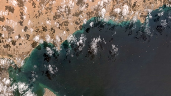 A general view of the ships waiting south of the Suez Canal due to the grounded Ever Given container ship, which is seen at far left stuck in the canal near Port Tawfiq. (VIA REUTERS)