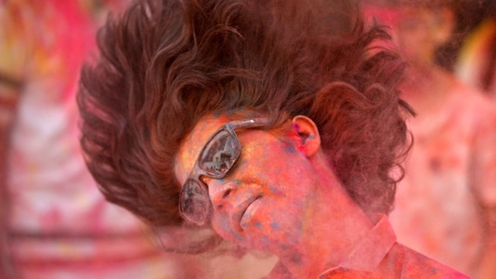 A boy smeared with coloured powder shakes his head to remove it during Holi celebrations, amidst the spread of the coronavirus disease (COVID-19), in Ahmedabad, India, March 29, 2021.  (REUTERS)