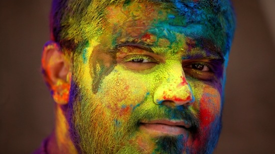 A man daubed in colours looks on during Holi celebrations, amidst the spread of the coronavirus disease (COVID-19), in Ahmedabad, India, March 29, 2021.  (REUTERS)