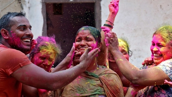 A woman reacts as coloured powder is applied on her face during Holi celebrations, amidst the spread of the coronavirus disease (COVID-19), in Mumbai, India, March 29, 2021. (REUTERS)